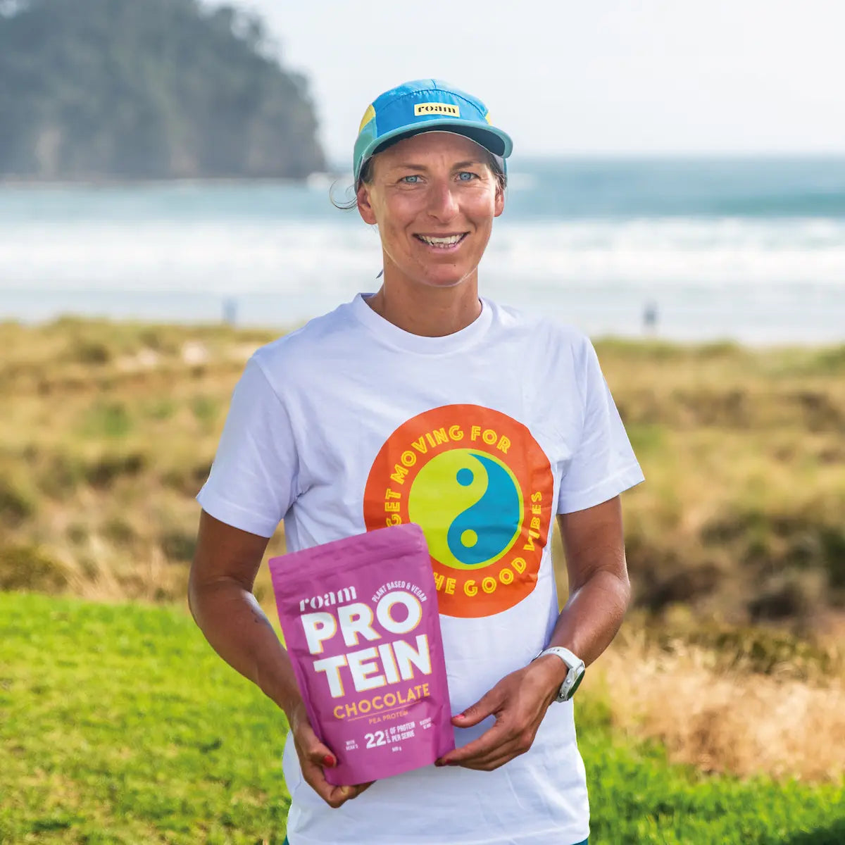 Female Pro Triathlete Holding Packet of Roam Chocolate Protein