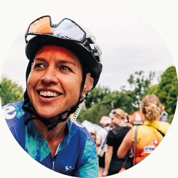 Female cyclist at an event with helmet and sunnies on
