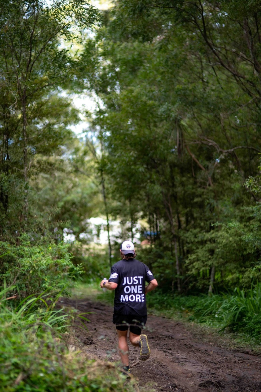 Male runner running on dirt forest trail | Roam | NZ Australia