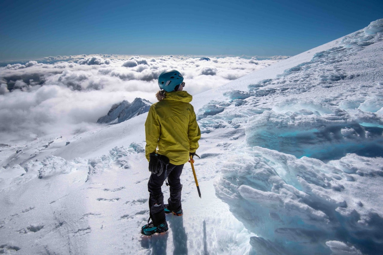 Female Mountaineer looking up icy slope | Roam | NZ Australia