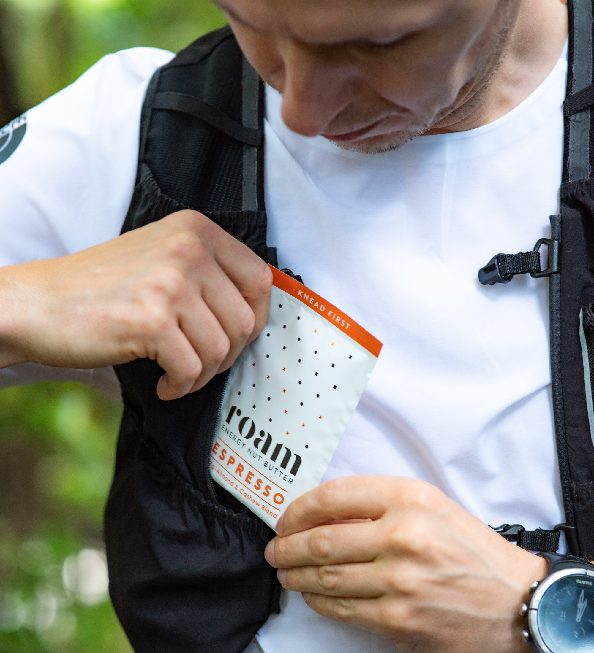 Trail Runner putting Roam Energy Nut Butter into running vest